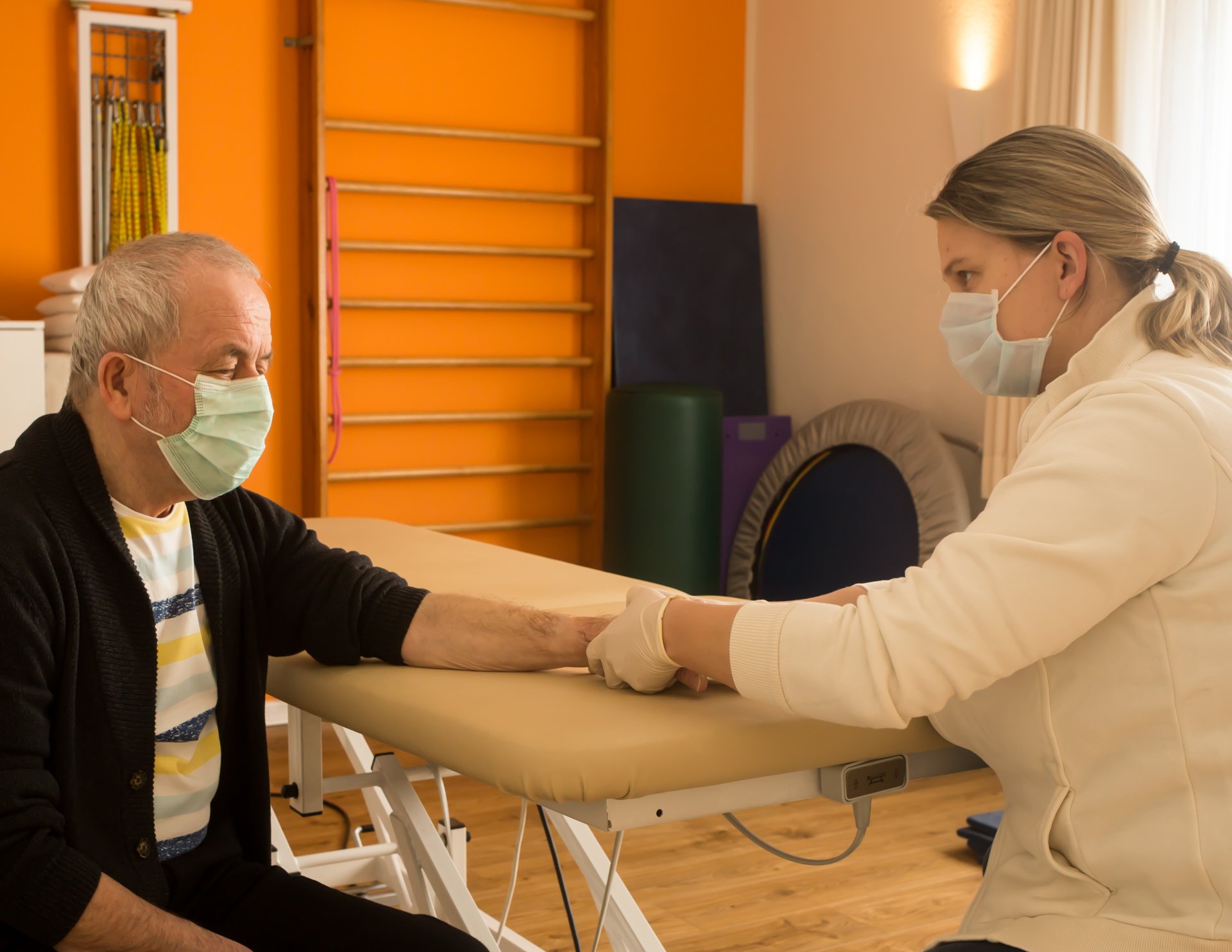 Anschlußbehandlung nach der Operation: Physiotherapeutin Sandra Okafor behandelt die Hand eines Patienten - Foto: Anna Bless